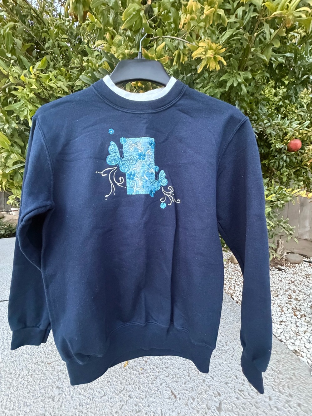 Top stitch wome Navy Sweatshirt with Turquoise Floral Patch size S gently used